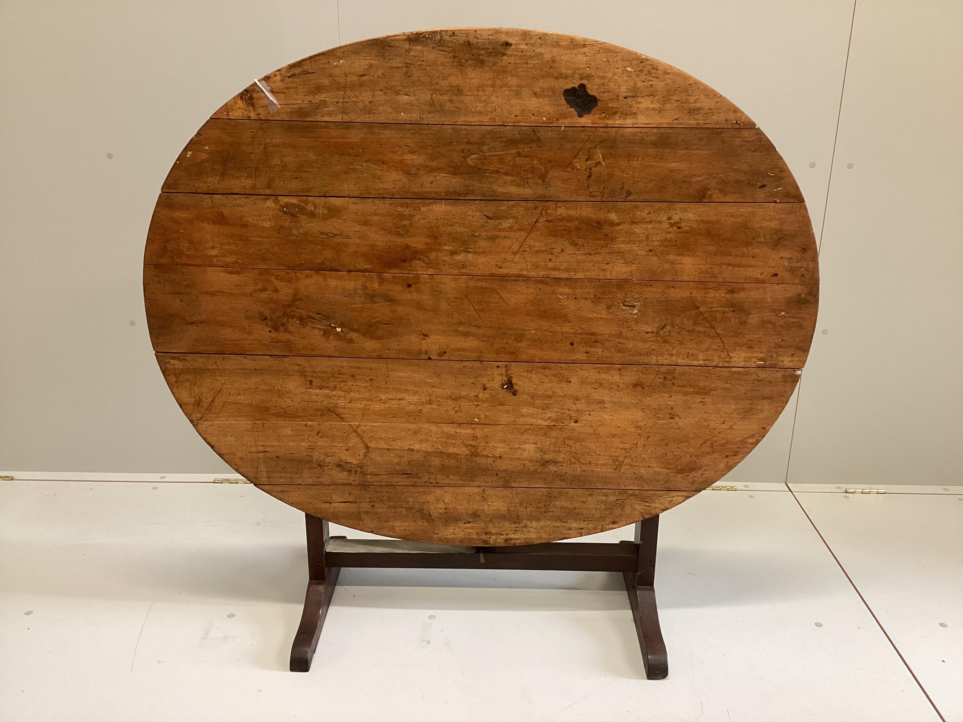 A 19th century French oval pine and fruitwood Vigneron, width 125cm, depth 101cm, height 72cm